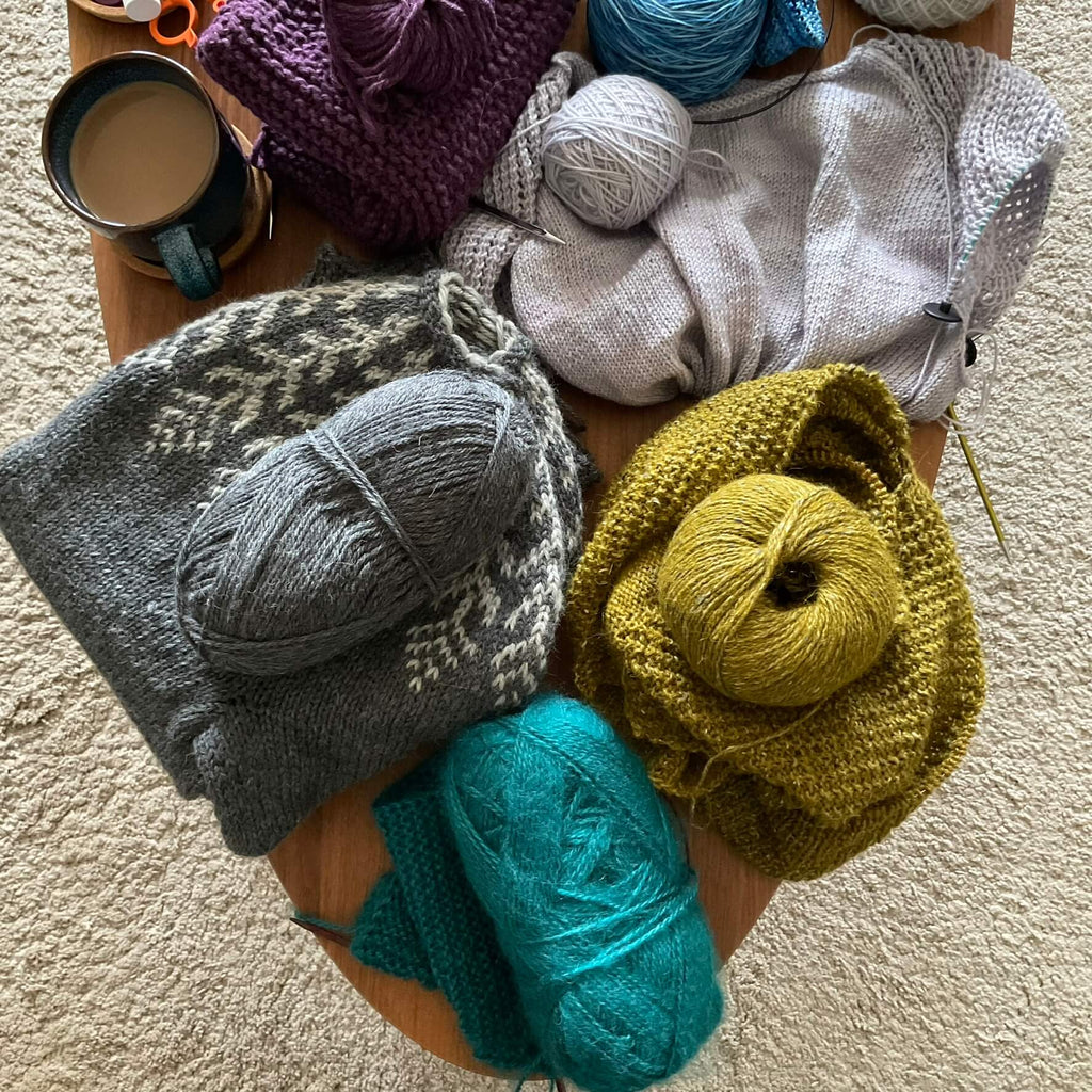 unfinished knitting projects on a coffee table