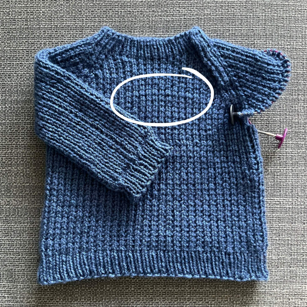 unfinished baby jumper with wonky stitches