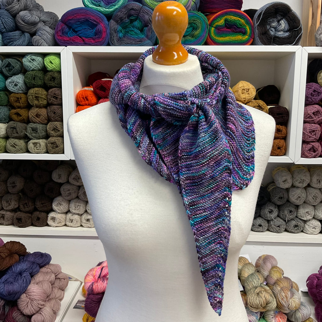 purple shallow triangle scarf tied around neck