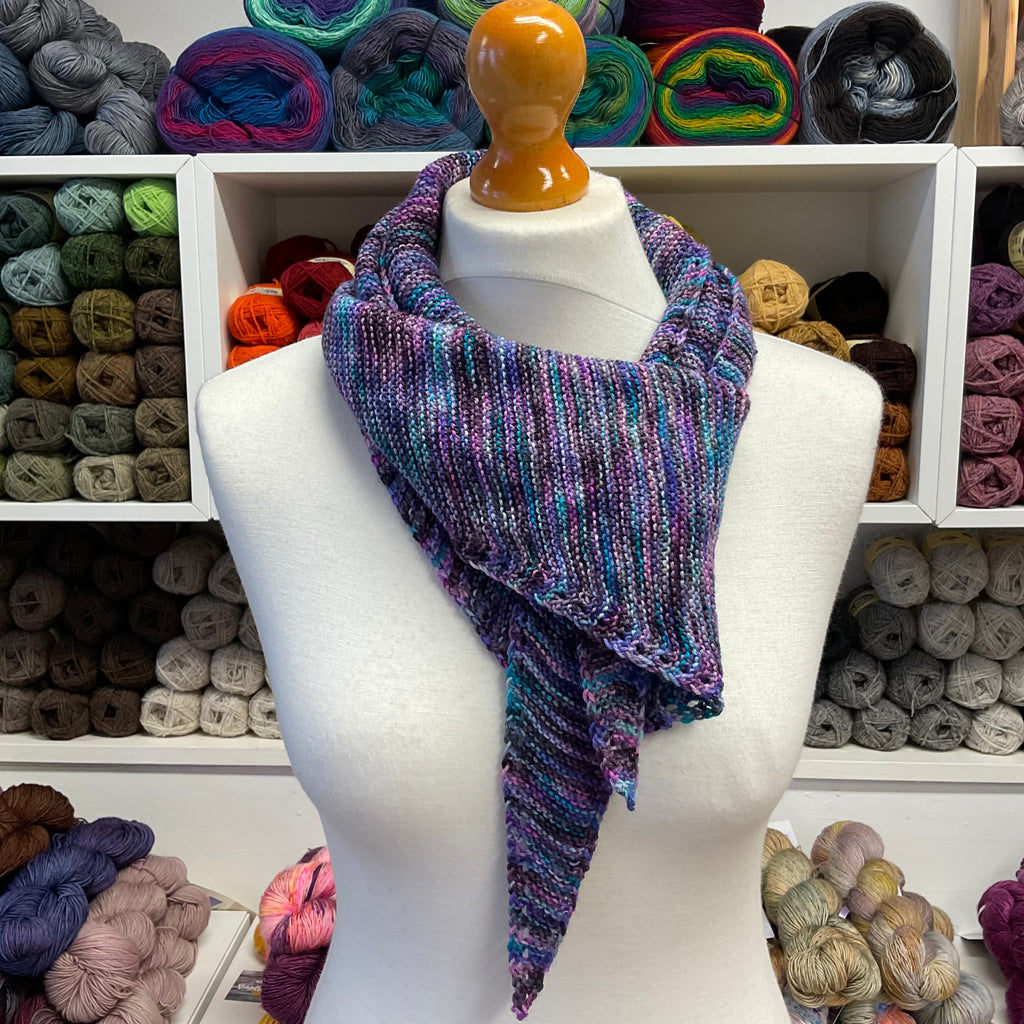 purple shallow triangle scarf looped around neck