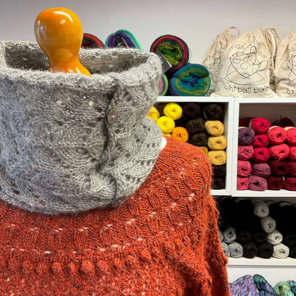 grey button cowl worn with orange jumper