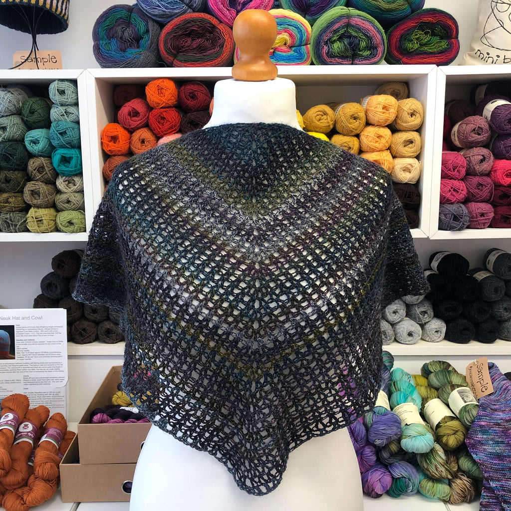 crocheted shawl in dark shades of purple and blue