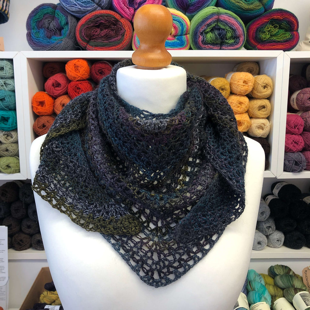 crocheted shawl in dark shades of purple and blue