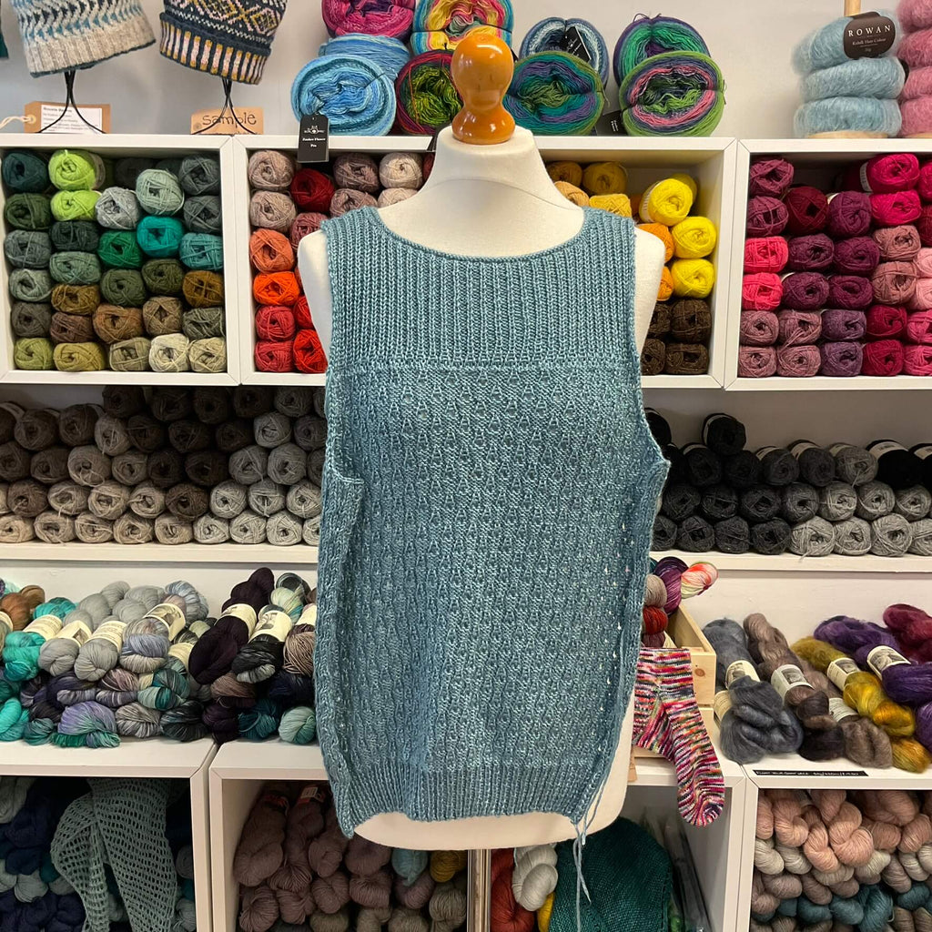 blue lacey sleeveless top on a mannequin