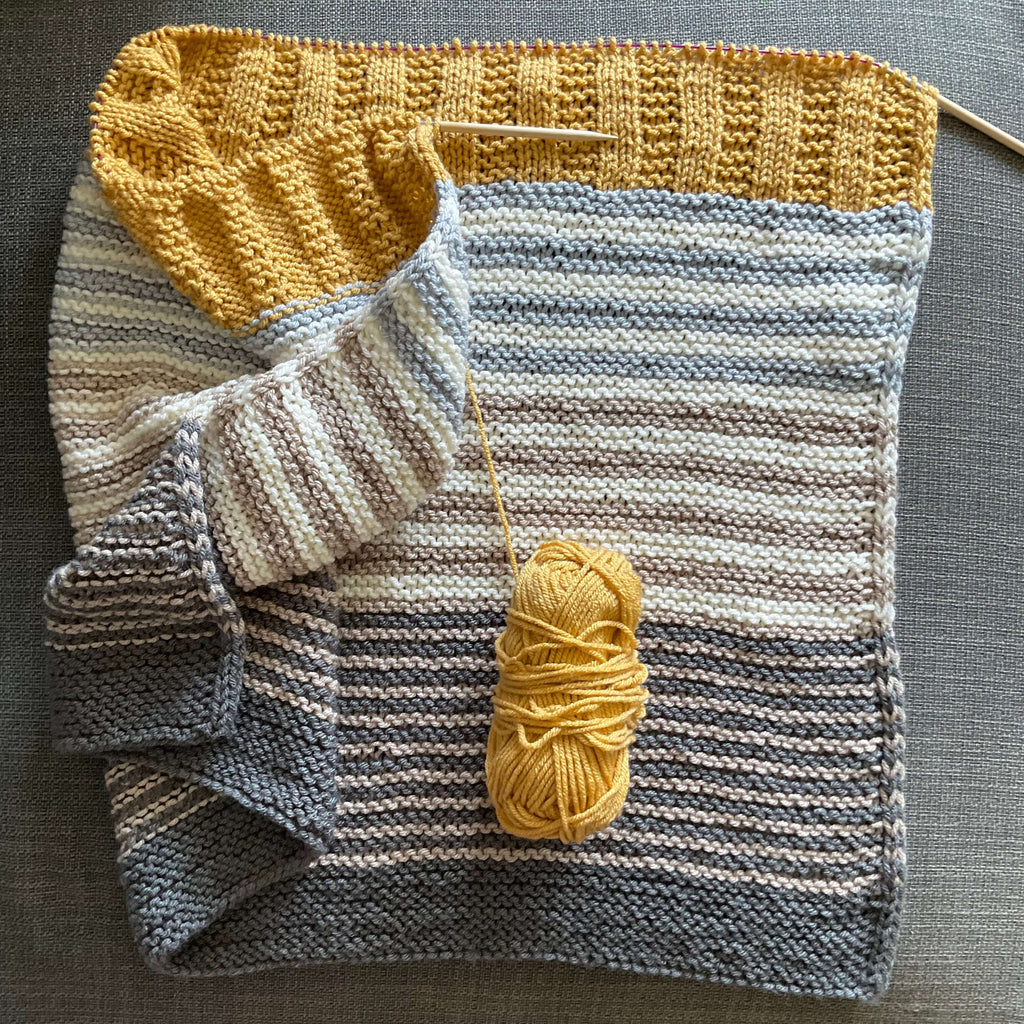 blanket in greys and yellows
