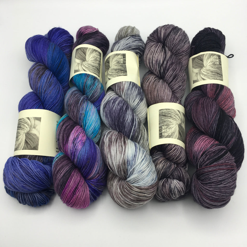 5 hanks of hand dyed yarn in shades of purple