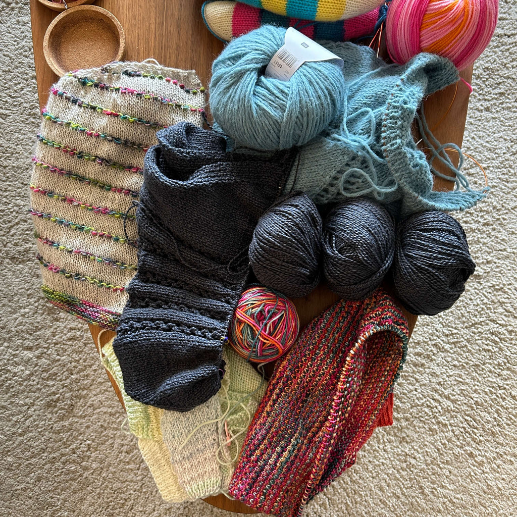 table of unfinished knitting projects