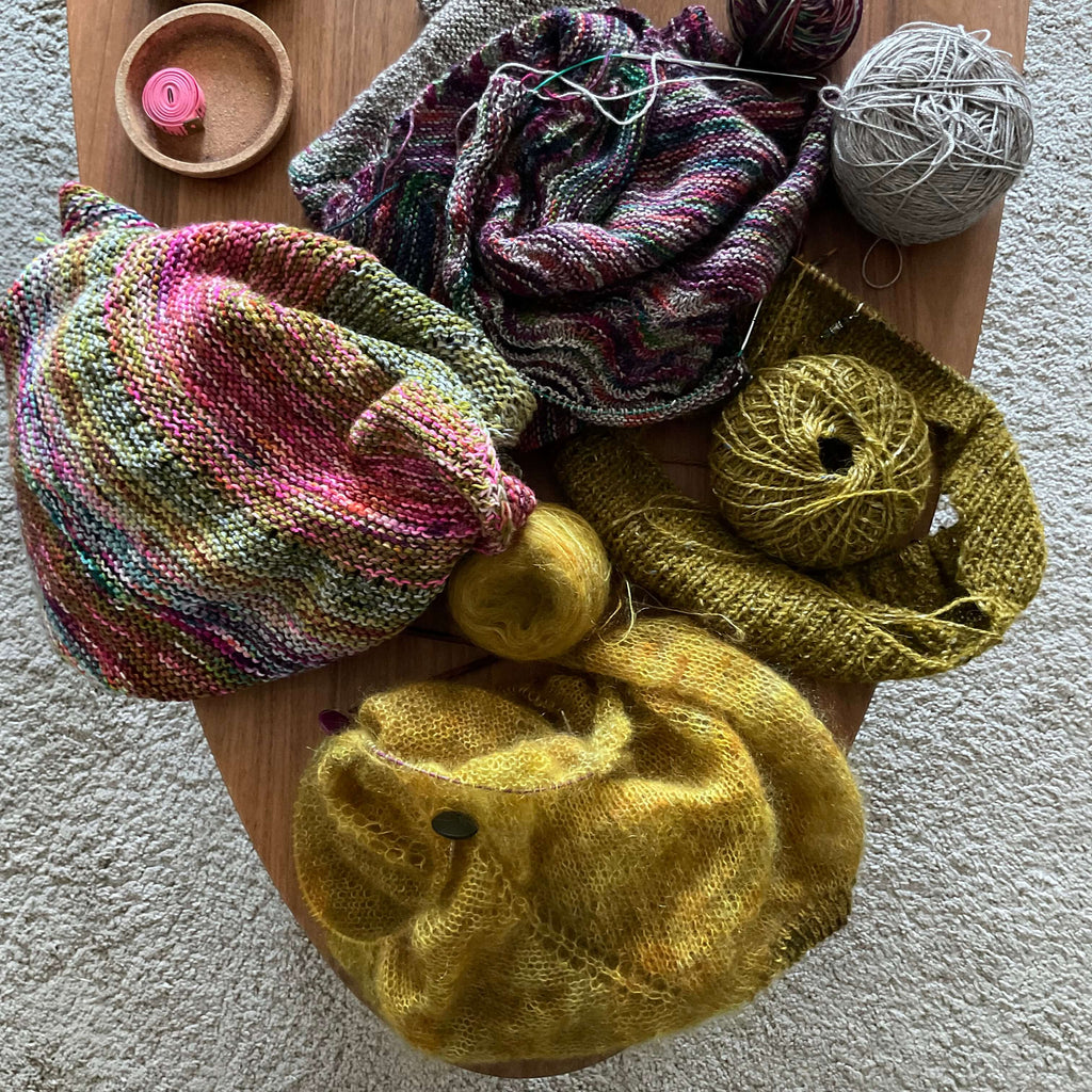 unfinished knitting projects on coffee table