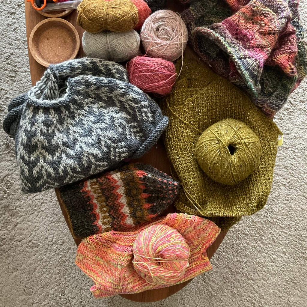 unfinished knitting projects on coffee table