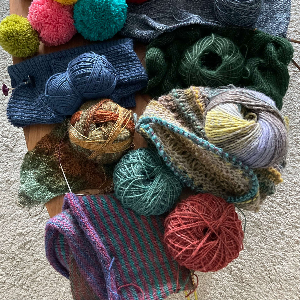 table full of knitting projects