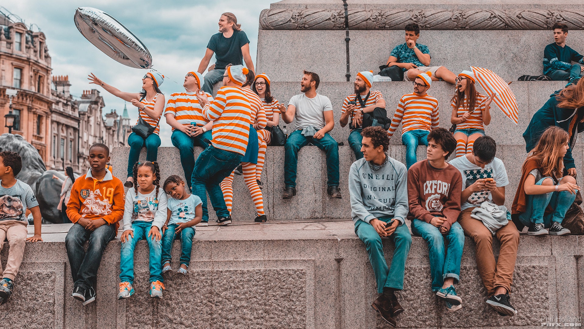 people sitting at the center of the town square, shot on Zeiss Otus Lenses