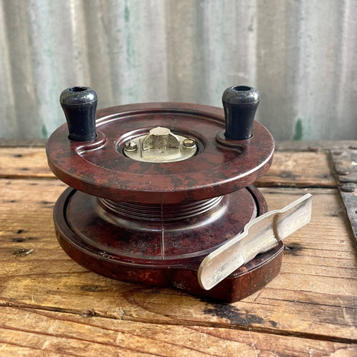 A Vintage Brass Fishing Reel with Flag Decoration together with Larger  Bakelite Example