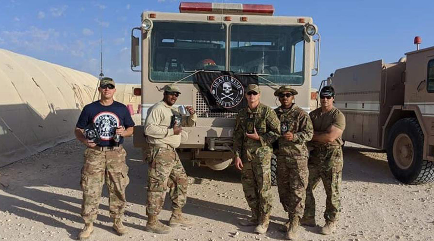 Military personnel posing with Death Wish Coffee donation