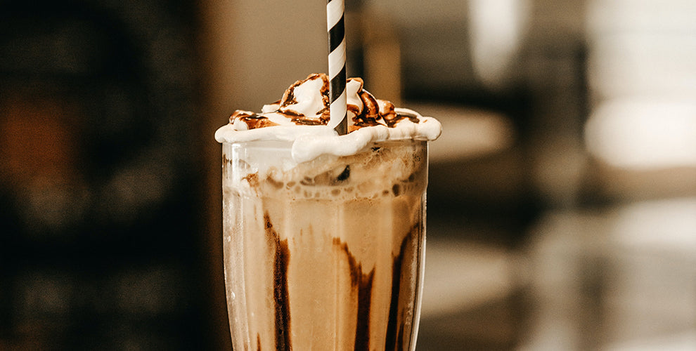 A nutella blended frozen coffee in a tall pint glass.