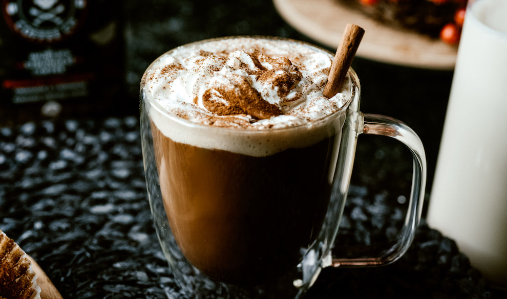 coffee in mug with whipped cream and cinnamon 