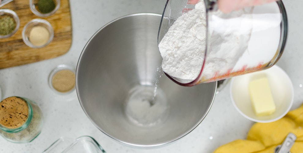 flour being poured into bowl