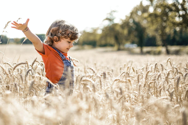 boy running through field