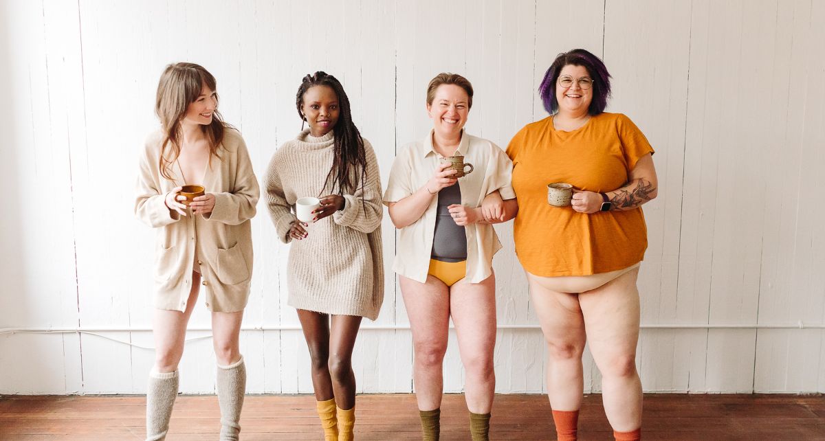 Four menstruators from diverse indenties stand in a line in their underwear