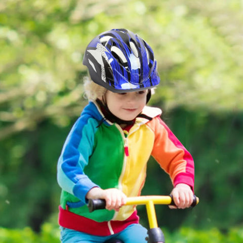 A child in a bicycle helmet rides a scooter