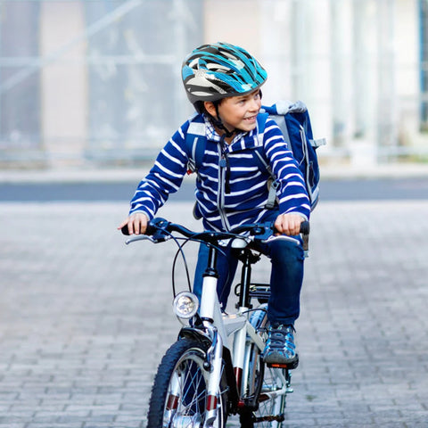A child in a bicycle helmet rides a bicycle