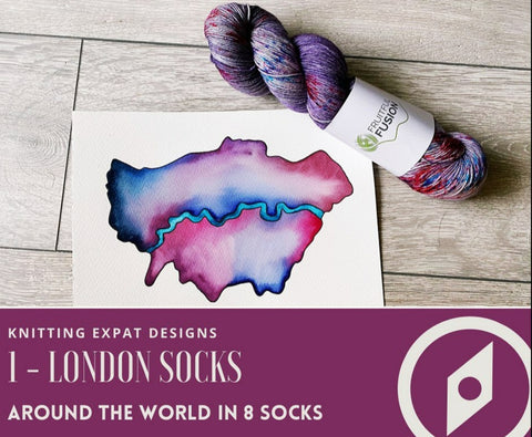 A skein of purple and grey with bright speckles laying next to a water colour postcard showing a map view of London.