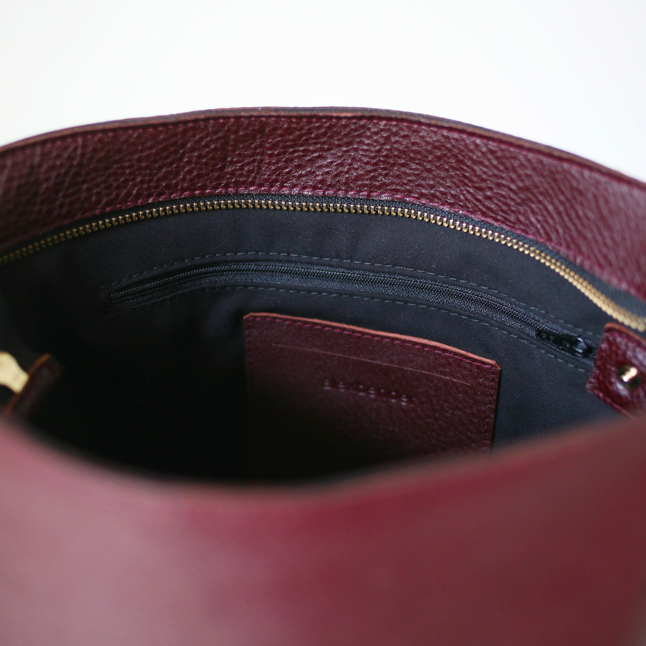 Load image into Gallery viewer, Close up of an open reddish brown Hobo Bag showing the lining
