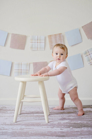 Baby wearing a onesie to illustrate one of the ways to dress your baby for Summer.