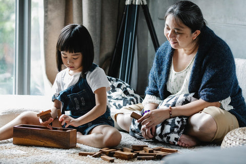 a mom and a child playing a puzzle game