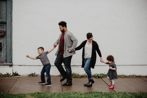 This family knows what to wear for family photos –  a family of four looking happy