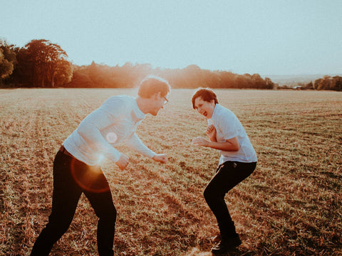 A father and son in matching outfits on a farm