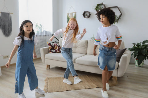 Three girls dancing in a living room