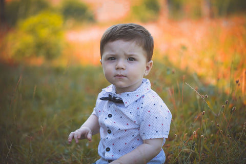 toddler boy wearing a short sleeved shirt