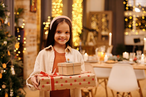 A girl holding Christmas presents