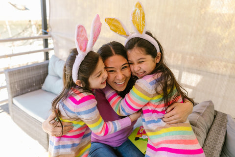 a mother and two daughters celebrating easter