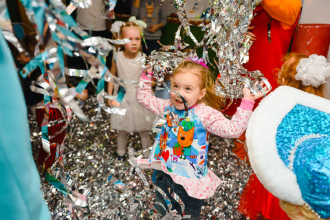 A girl playing with confetti