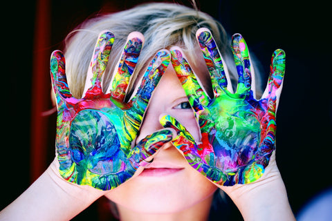 a boy with colorful painted hands