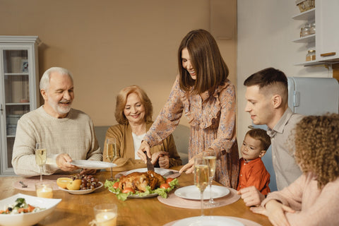 A family sharing a Thanksgiving turkey