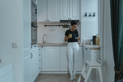 Pregnant woman in the kitchen thinking about how to prepare a home for a new baby