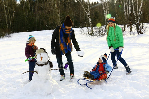 A family building a snowman
