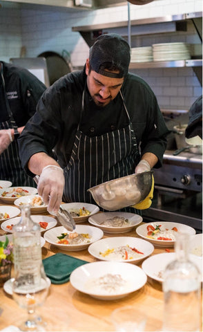 Chef Adding Garnish Before Service