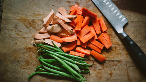 French Beans and Chopped Sweet Potatoes Carrots on a Wooden Board