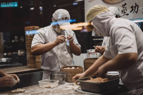 busy chefs preparing soup dumplings before operations