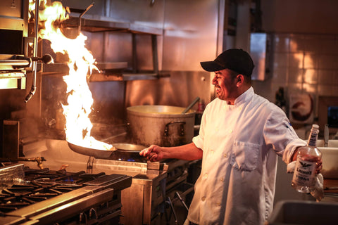 chef demonstrating how to flambe food like a pro