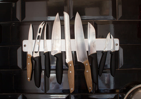 different types of knives in a magnetic knife rack