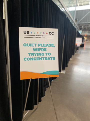 A sign at the US Roaster championship reads "quiet please, we are trying to concentrate"