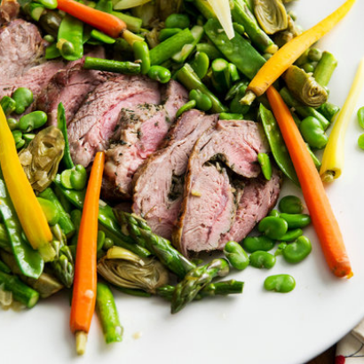 colorful platter of roasted lamb and spring vegetables
