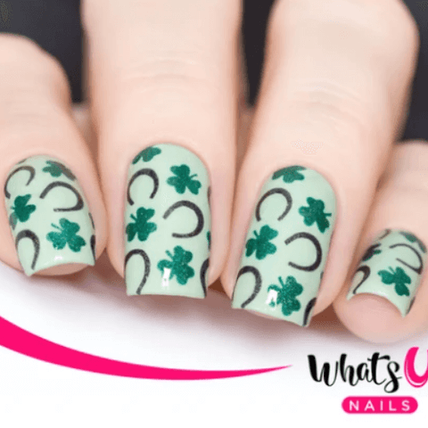 green clovers and black horseshoes on white nail polish