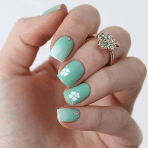 white clovers on mint green nail polish
