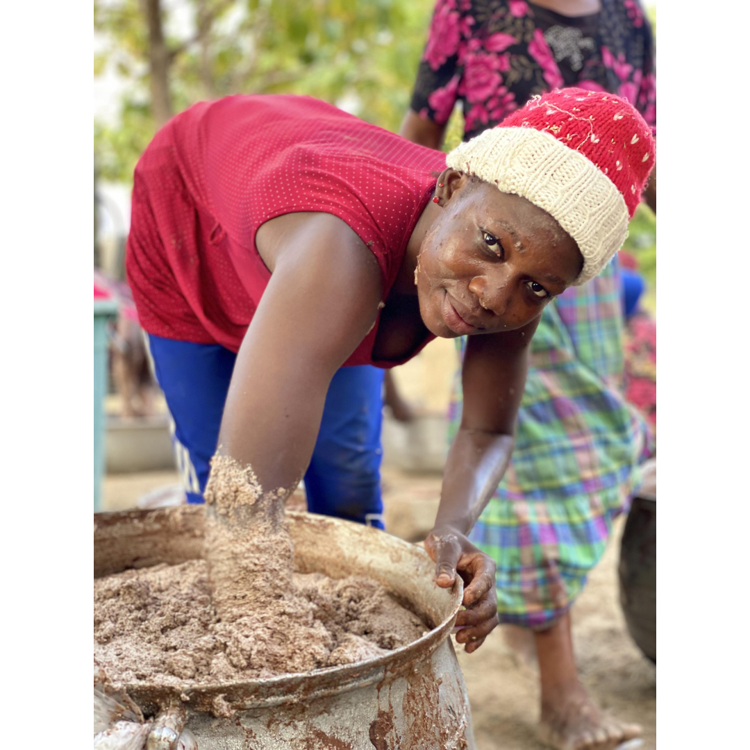 Abudi Amina kneading water into the milled and roasted shea nuts