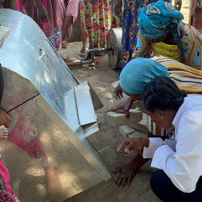 Women are learning how to carefully set up the roasters.